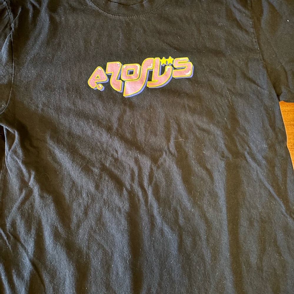 A medium T-shirt with a bunch of graphics on it and it looks really cool